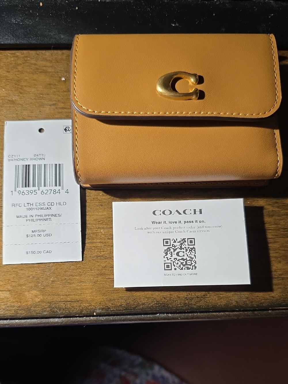 Coach Compact Wallet in Honey Brown with Gold Hardware.